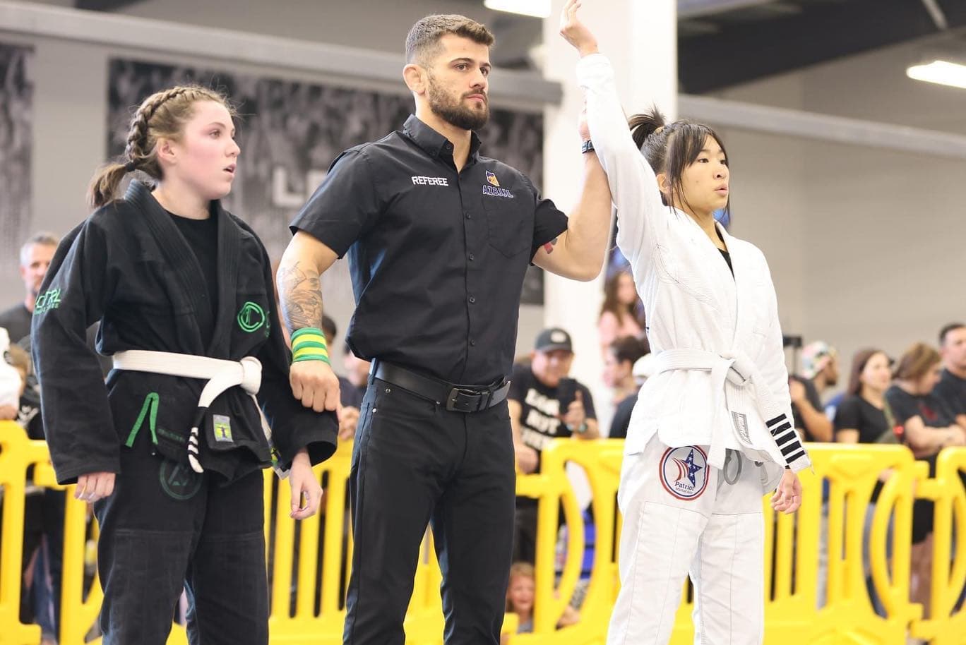 Young competitor getting her hand raised in victory